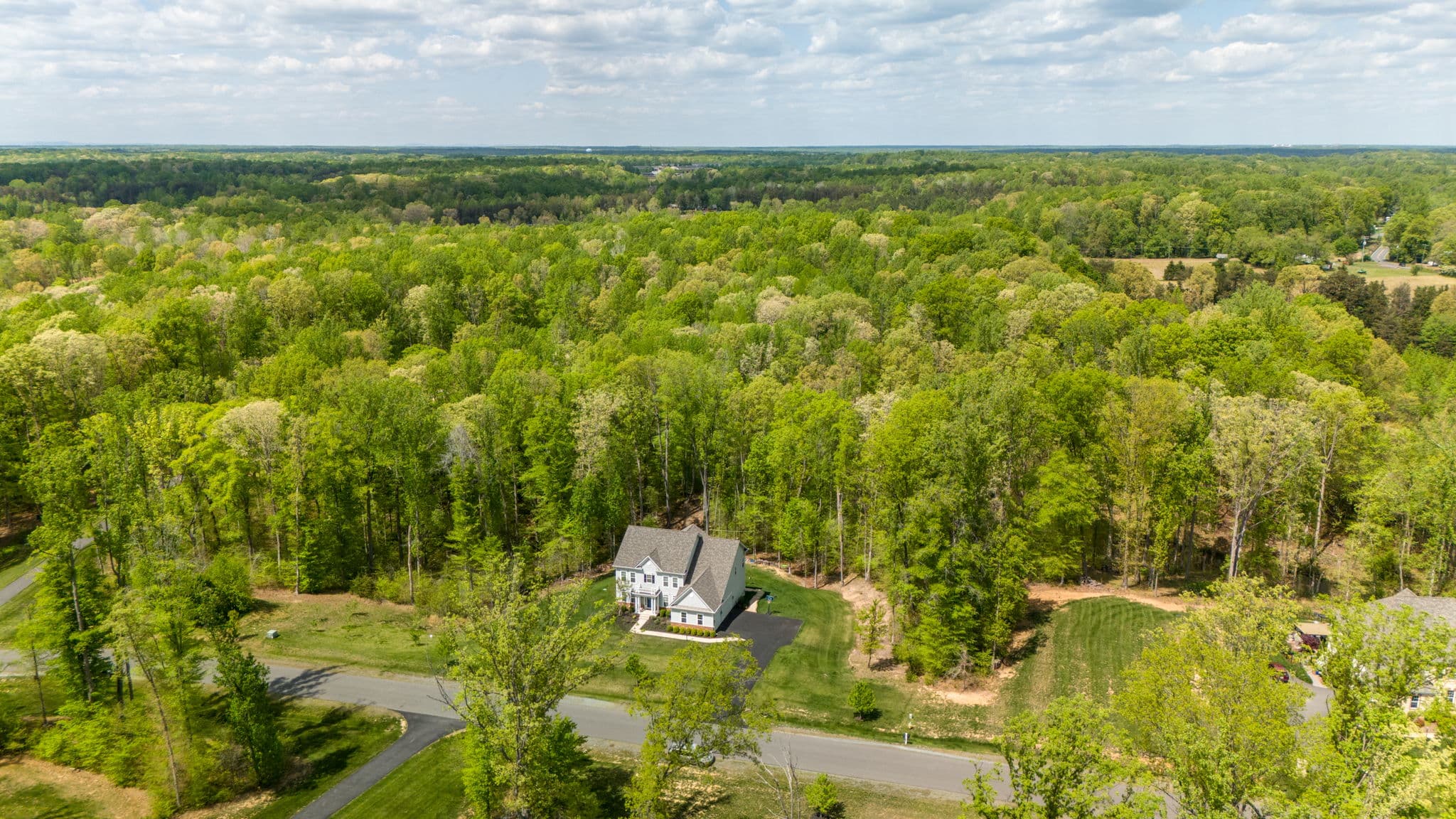 An aerial view of a leafy Mid-Atlantic neighborhood of homes